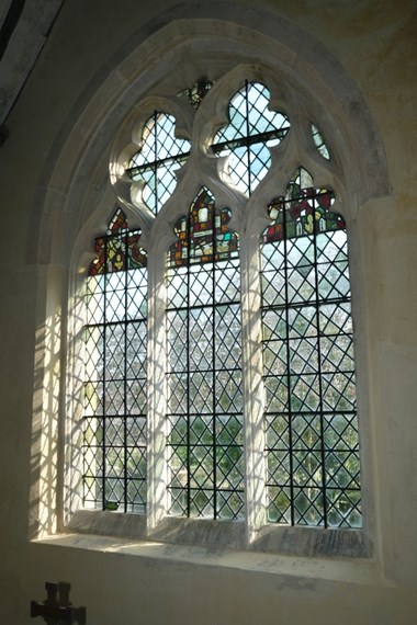 Photograph of a newly restored stained glass window, from the inside. 