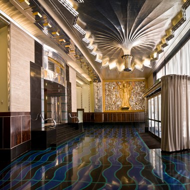 The interior of an office building entrance area showing opulent art deco decoration.