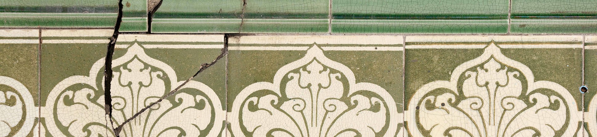 Original Pilkington tiles in green and cream. Some of them are cracked.