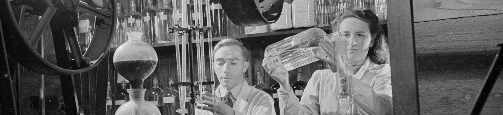 Man and woman working with scientific equipment.