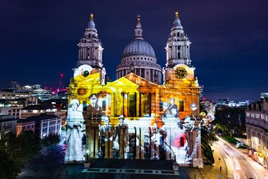 Image of King George VI and Queen Elizabeth and other men, some in tin hats, projected on the west elevation of St Paul's Cathedral.